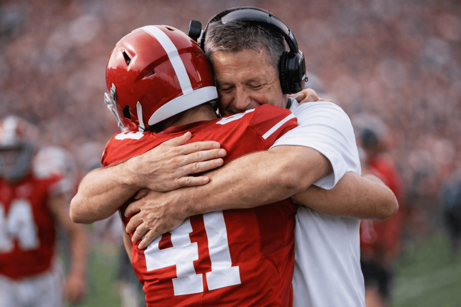 Coach embracing athlete